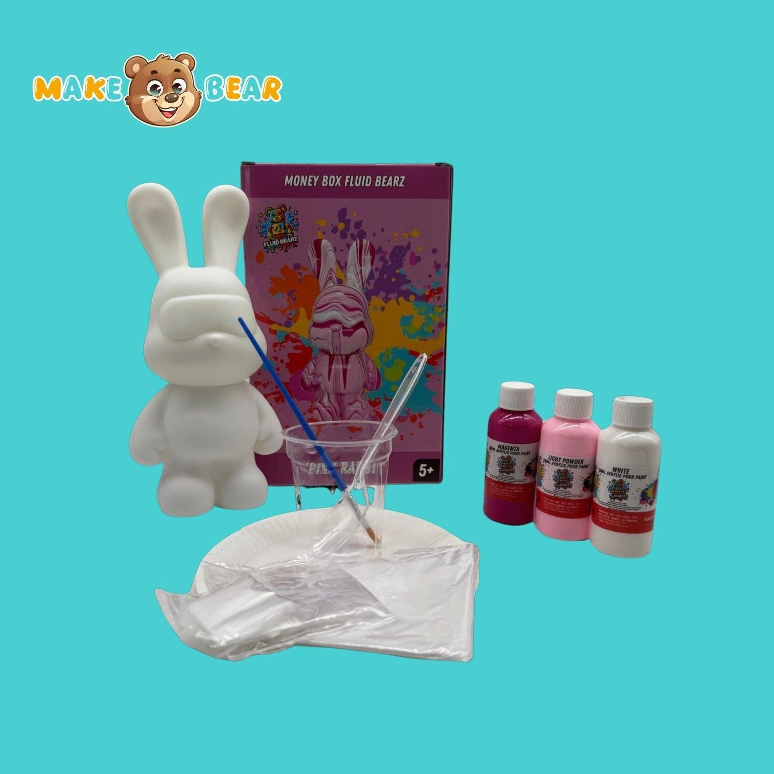 Overzicht van de Fluid Bearz DIY-kit met konijnvormige spaarpot (23 cm), roze, witte en paarse verf, mengbekers, lepels, handschoenen, instructieboekje en beschermmatje.